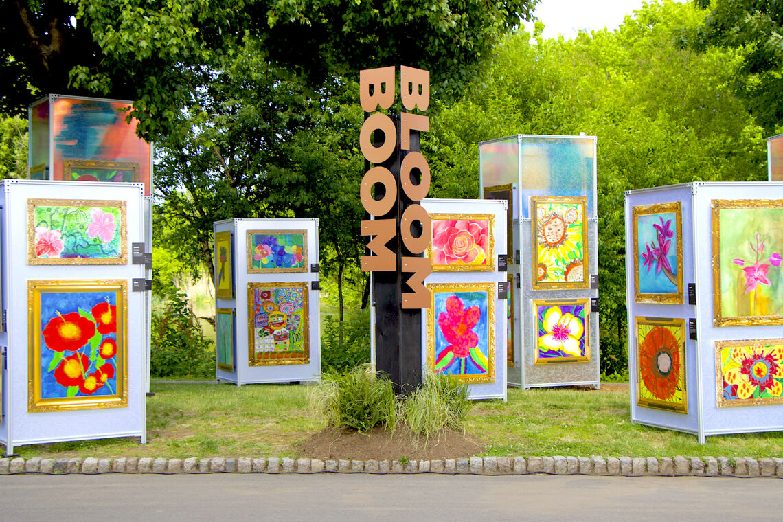 A group of art pieces sitting on top of a grass covered field
